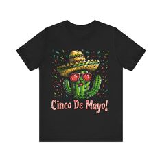 Jump into the festive spirit with our "Desert Fiesta" T-shirt! This vibrant tee captures the essence of Cinco de Mayo with a playful cactus character, decked out in a sombrero and cool shades, ready to party. Whether you're dancing at a fiesta or just bringing the party vibes to your everyday life, this t-shirt is the perfect way to celebrate the day. With a pop of color and a dash of Mexican flair, it's a wearable fiesta and a great conversation starter. Perfect for Cinco de Mayo or any day you want to celebrate life, this tee is a must-have for those who love to have fun with their style! This classic unisex jersey short sleeve tee fits like a well-loved favorite. Soft cotton and quality print make users fall in love with it over and over again. These t-shirts have-ribbed knit collars to Cinco De Mayo Screen Print Crew Neck T-shirt, Cinco De Mayo Graphic Tee With Short Sleeves, Cinco De Mayo Graphic T-shirt, Black Crew Neck T-shirt For Cinco De Mayo, Cinco De Mayo Graphic Print T-shirt, Casual Cinco De Mayo T-shirt With Funny Print, Cinco De Mayo Funny Print Crew Neck T-shirt, Casual T-shirt With Funny Print For Cinco De Mayo, Cinco De Mayo Graphic Tee With Letter Print