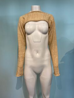 a white mannequin with a yellow sweater on it's chest and back