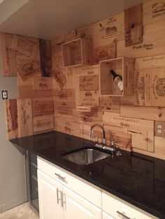 a black counter top sitting under a wooden wall