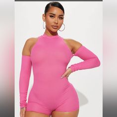 a woman wearing a pink bodysuit with high neck and long sleeves, posing for the camera