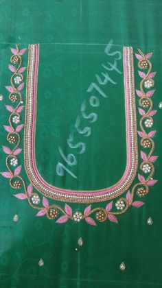 an embroidered green cloth with pink and white beads