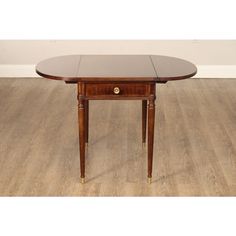 an oval shaped table with two leaves on the top and one drawer at the bottom