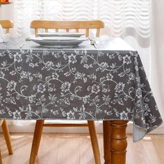 a dining room table with a plate on it and two chairs in front of the table