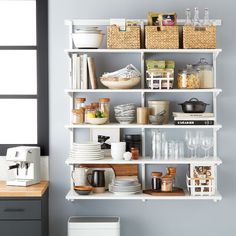 a kitchen shelf filled with dishes and cups