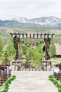 an outdoor ceremony set up with mountains in the background