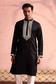 SHRESTHA BY VASTRAMAY Men's Black Silk Machine Embroidered Kurta Elegant and trendy, this black kurta features machine embroidery on the neckline. Made from a silk blend, it has a mandarin collar, long sleeves, and side slits for added comfort. Key Features Black silk blend with machine embroidery Mandarin collar Long sleeves Side slits Specifications Knee length Material & Care Top fabric: Silk blend Dry clean only Legal Disclaimer: The product is guaranteed to be 100% genuine. Product images a Casual Black Festive Kurta, Black Long Sleeve Kurta For Festive Occasions, Black Long Sleeve Festive Kurta, Black Cotton Long Sleeve Kurta, Traditional Black Long Sleeve Kurta, Black Long Sleeve Kurta With Chikankari Embroidery, Black Kurta With Floral Embroidery For Eid, Black Cotton Kurta With Embroidered Border, Black Embroidered Kurta For Eid