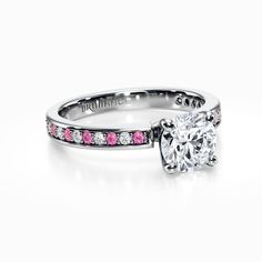 a diamond and pink sapphire engagement ring on a white background with the words brilliant written in silver