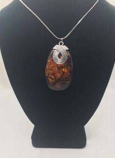 This exquisite necklace, set in sterling silver, is adorned with the finest and most valuable amber in the world - a captivating specimen originating from the Baltic Sea. Its classic Italian chain adds a touch of timeless elegance. For those seeking a jewelry piece of significance, this magnificent pendant is the perfect choice. Since antiquity, Baltic amber has been held in high regard for its unparalleled beauty, warmth, and magical luster. Sterling Silver Chain: 20" (1.25mm) sterling silver Italian Wheat chain stamped JTI925.Amber: 2.25" long x 1.5" wideMetal: Sterling SilverOnly One AvailableEconomy Shipping via USPSWe guarantee your satisfaction in our products. Baltic Amber Gemstone Necklaces, Amber Sterling Silver Necklaces With Cabochon, Amber Cabochon Necklace In Sterling Silver, Amber Sterling Silver Necklace With Cabochon, Amber Cabochon Necklaces In Sterling Silver, Amber Citrine Round Pendant Jewelry, Amber Sterling Silver Necklace For Healing, Elegant Amber Pendant Necklace, Formal Oval Amber Necklace