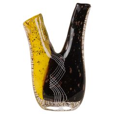 a black and yellow vase sitting on top of a table