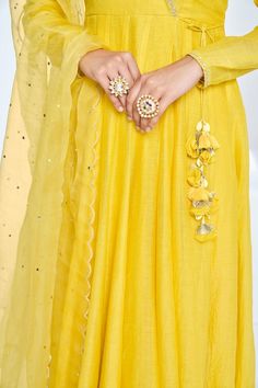 Bright yellow soft chanderi angrakha anarkali with aari, pita and mukaish embroidered neckline. Comes with pant and a dupatta.
Components: 3
Pattern: Embroidered
Type Of Work: Aari, Pita, Mukaish
Neckline: V Neck
Sleeve Type: Full
Fabric: Anarkali: Soft chanderi, Pant: Cotton stretch, Lining: Chanderi
Color: Yellow
Other Details: 
Attached lining
Length:
Anarkali: 52 inches
Sleeves: 23 inches
Pant: 38 inches
Dupatta: 2.5 mtrs
Occasion: Mehendi and Haldi - Aza Fashions Festive Long Lehenga With Dori Work, Long Anarkali Set With Dori Work For Eid, Anarkali Lehenga With Dori Work, Wedding Floor-length Kurta With Gota Work, Transitional Gold Anarkali Set With Dori Work, Semi-stitched Long Anarkali Set With Dori Work, Long Semi-stitched Anarkali Set With Dori Work, Long Chanderi Anarkali Set For Wedding, Wedding Chanderi Long Anarkali Set