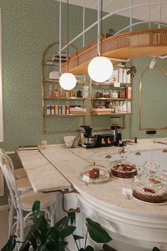 a kitchen counter topped with pies and cakes next to a potted green plant