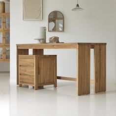 a wooden desk sitting in the middle of a room