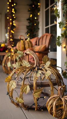 an outdoor porch decorated for fall with pumpkins and gourds