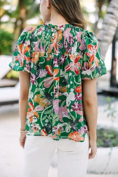 We hope you have all the plans for this blouse! It's sure to take you from the office to the beach side restaurant! That tropical floral print is so fun and colorful! Round neckline Smocked yoke Button keyhole back Short bubble sleeves Tropical floral print No stretch Savannah is wearing the small. Hawaiian V-neck Top With Tropical Print, Spring Vacation Tops With Elastic Neckline, Summer Vacation Blouse With Elastic Neckline, Summer Blouse With Elastic Neckline For Vacation, Spring Beach Top With Elastic Neckline, Floral Print Short Sleeve Smocked Top For Brunch, Floral Print Smocked Top For Brunch, Summer Beach Top With Elastic Neckline, Floral Print Smocked Top With Short Sleeves For Brunch