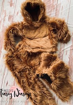 a teddy bear laying on top of a wooden floor