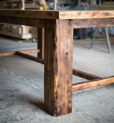 a wooden table sitting on top of a cement floor