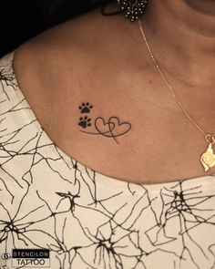 a woman with a dog paw and heart tattoo on her chest