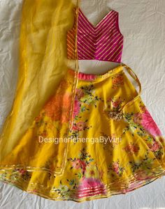 Custom made lehenga choli for kids of all ages. Fabric details- Top- Silk with gota work Lehenga- Georgette in floral print Dupatta- Net with gold trims. Made to measure. Customisation possible. Contact for kids dresses above 11 years. Can be made as a mother-daughter dress or outfit. This dress can also be made in womens size. Contact for price for women's size. Contact for custom sizing after placing the order or we will contact you after you place the order. Designer Wear Lehenga With Traditional Drape For Summer, Summer Festive Lehenga With Traditional Drape, Fitted Lehenga For Designer Summer Wear, Bollywood Style Georgette Lehenga For Summer, Summer Designer Wear Fitted Lehenga, Summer Party Wear Sets With Dupatta, Summer Lehenga With Zari Work, Summer Anarkali Lehenga With Traditional Drape, Summer Georgette Choli With Dupatta