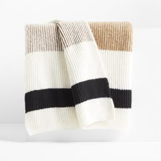 a white blanket with black and tan stripes