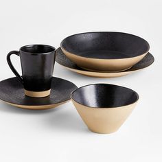 three black and gold plates with cups on them, one has a saucer in the middle