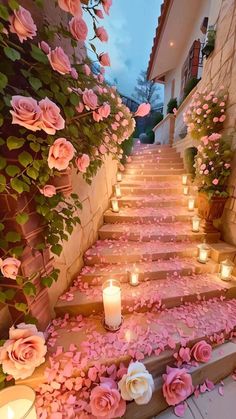 the steps are covered with pink flowers and lit candles