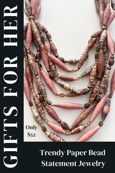 a strand of pink and brown beads on a white background with the words, trendy paper bead statement jewelry