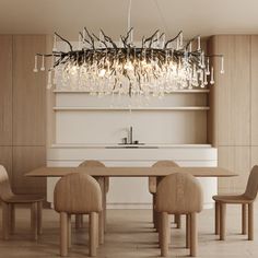 a chandelier hanging from the ceiling over a dining room table with four chairs