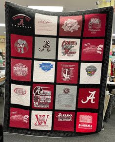 a quilt made to look like it has many different college logos and letters on it