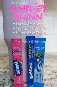 three packets of blue raspberry are on the counter next to a toothbrush