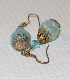 The earrings are composed of czech glass beads, swarovski crystals and antiqued filgree accents and gold ear wires. I am a SARJD #3614, (self-representing artist in jewelry design) and all of my designs are OOAK, (one of a kind). All items will be packaged in a box for jewelry and wrapped in bubble wrap then a bubble mailer for extra security. Shipping is next day after payment is received. If you have any questions please contact me before you buy. Vintage Turquoise Earrings For Party, Party Earrings With Czech Glass, Elegant Round Beaded Earrings With Faceted Beads, Elegant Czech Glass Earrings For Jewelry Making, Elegant Czech Glass Earrings For Pierced Ears, Elegant Czech Glass Earrings, Elegant Turquoise Beaded Earrings For Party, Blue Round Bead Earrings For Wedding, Elegant Turquoise Beaded Earrings For Gift