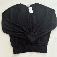 Women’s Evereve Black V-Neck Smocked Long-Sleeved Top, Size L. Never Worn, New With Tags. Stretch V-neck Top With Smocked Bodice, Fall V-neck Top With Elastic Sleeves, Trendy V-neck Top With Smocked Back, Casual V-neck Top With Smocked Back, V-neck Smocked Top For Brunch, Trendy Long Sleeve Smocked Top With Elastic Sleeves, Trendy Smocked Top With Long Elastic Sleeves, Long Sleeve Smocked Stretch Top For Brunch, Chic Stretch Smocked Long Sleeve Top