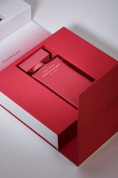 an open red box sitting on top of a white table