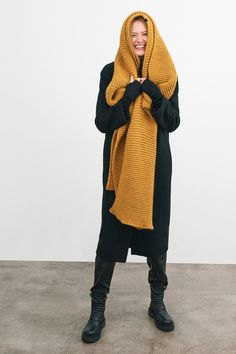 Make your style A LOT cozier with our extra-long Bronx Scarf. Bronx is both knit from ultra-soft French Merino Wool mix to warm your soul and fashioned extra long to make a statement. Wrap this Merino wool scarf around and around for volume, or wear her draped over your shoulders to lend your look texture and drama. This soft wool scarf also doubles perfectly as an airplane blanket. | Emmy, in burnt yellow, is 5'10.5" (179 cm), wearing size XS. Natalee, in medium grey, is 5'10" (178 cm) tall. As Knit Scarf Outfit, Burnt Yellow, Airplane Blanket, Chunky Infinity Scarves, Big Scarf, Big Knits, Merino Wool Scarf, Yellow Scarf, Scarf Outfit