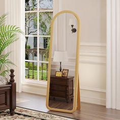 a large mirror sitting on top of a wooden floor next to a dresser and window