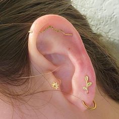 a close up of a person with ear piercings