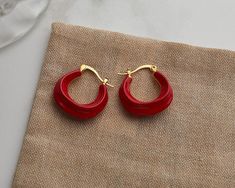 Add some whimsy to your look with these enamel chunky hoops. Perfect for daily wear and plated with 14k gold vermeil, these wavy hoop earrings come in a playful array of white, green, red, black, and brown. About 23mm in diameter, they're dainty yet elegant, making them the perfect accessory for any occasion. Trendy Red Hoop Earrings, Modern Red Small Hoop Earrings, Modern Small Red Hoop Earrings, Trendy Small Red Hoop Earrings, Trendy Small Hoop Red Earrings, Trendy Red Hoop Earrings For Everyday, Red Enamel Hoop Earrings Gift, Red Enamel Hoop Earrings For Gifts, Trendy Red Enamel Earrings