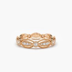 a rose gold ring with three diamonds on the side and two rows of leaves in the middle