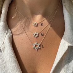 The 14K Gold Star Of David Diamond Necklace is commonly referred to as the Shield of David or Magen David in Hebrew. This symbolic necklace represents protection, providence, and good luck. Pair it with our Hebrew nameplates or other Star of David jewelry to create a meaningful and personal look that showcases your faith. Item Information Metal: 14k Gold Weight: Small - 2.00g Medium - 2.60g Large - 3.30g Chain Length: 16"+1"+1" Dimensions: Small - 10mm Medium - 12.5mm Large - 16.5mm Carat Weight: Small - 0.10 Medium - 0.16 Large - 0.48 Body Jewelry Men, Star Of David Necklace, Rainbow Pearl, Symbol Necklace, Blue Accessories, The Shield, Popular Jewelry, Star Of David, Pendant Rings