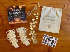 the contents of a christmas ornament laid out on a wooden floor next to a book