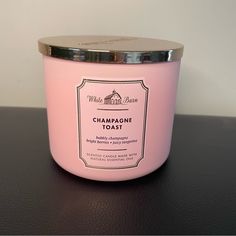 a pink candle sitting on top of a table