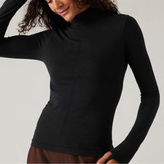 Athleta Ascent Seamless Turtleneck. Size Small. New With Tags. For: Commute, Travel, Hiking In Cold Weather Climates Feel: New And Improved Merino Wool Yarn Is Ultra-Soft, Lightweight, And Resists Pilling Fave: Pointelle Stitching Down The Front For Breathability Close-To-Body Fit Make It The Perfect Base Layer Light Mesh Structure On Back Facilitates Ventilation Wool/Nylon Seamless: Beyond-Soft, Chafe-Free Fabric Stretches With Every Move Breathable: Airflow Moves Easily Through The Garment Machine Wash And Lay Flat To Dry. Fitted Next To The Body Regular Length, Hits At Low Hip T-Neck Body Length In Size Medium: Regular: 22" Athleisure Stretch Turtleneck Tops, Athleisure High Neck Tops With Thumbholes, Functional Stretch High Neck Tops, Stretch High Neck Sports Top, Stretch High Neck Tops For Yoga, High Neck Stretch Top For Sports, Stretch High Neck Yoga Tops, High Neck Stretch Sports Top, High Neck Stretch Tops For Yoga