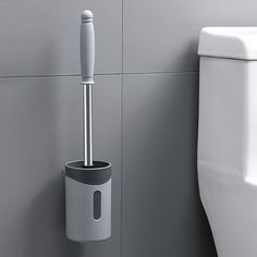 a white toilet sitting next to a gray urinal