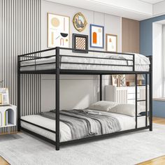 a bunk bed in a room with blue walls and wood flooring, along with pictures on the wall