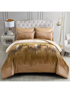 an image of a bed with gold comforter and pillows