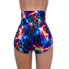 High-waisted booty shorts made in sparkle cosmic thunder UV Glow print stretchy performance spandex with ruching on the sides and lace-up detail in front. Made to flatter your figure and move with you. These booty shorts shine in different colors in the light - for a true holographic effect. The standard inseam is 2.5" - but can be customized. High Waist Shorts For Cheerleading In Summer, Trendy Fitted Shorts For Swimming, Trendy Fitted High Waist Athletic Shorts, Stretch Rave Shorts, Fitted Rave Bottoms With Built-in Shorts, Fitted High Waist Athletic Shorts For Swimming, High Waist Stretch Bottoms For Rave, Trendy Stretch Bottoms For Cheerleading, Fitted Rave Shorts