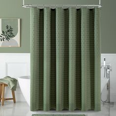 a green shower curtain in a bathroom next to a white bath tub and wooden stool