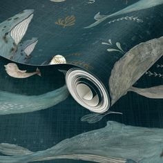 an artistic wallpaper with sea animals and plants on the ocean floor, as well as a roll of fabric