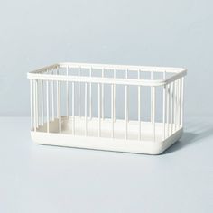 a small white crib sitting on top of a table