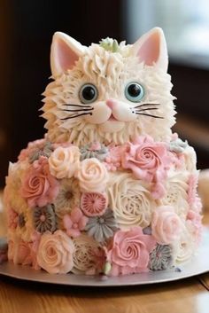 a cake decorated with flowers and a cat's face