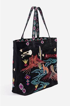 Striking in color and design, the Arizona Everyday Tote adds a statement-making twist to a timeless everyday style. Inspired by the landscape of Arizona, this tote bag is crafted from pure cotton and boasts two patterned top handles, a printed lining, and a colorful placement embroidery complete with floral, star, and cactus motifs. Pair with a flowy dress on your warm-weather getaway or style with pants and a pullover for a playful daytime ensemble. Johnny Was Women's Arizona Everyday Tote Bag Bags Grunge, Style With Pants, Cactus Motif, Placement Embroidery, Cute Handbag, Everyday Tote Bag, Embroidered Tote Bag, Europe Outfits, Velvet Clothes